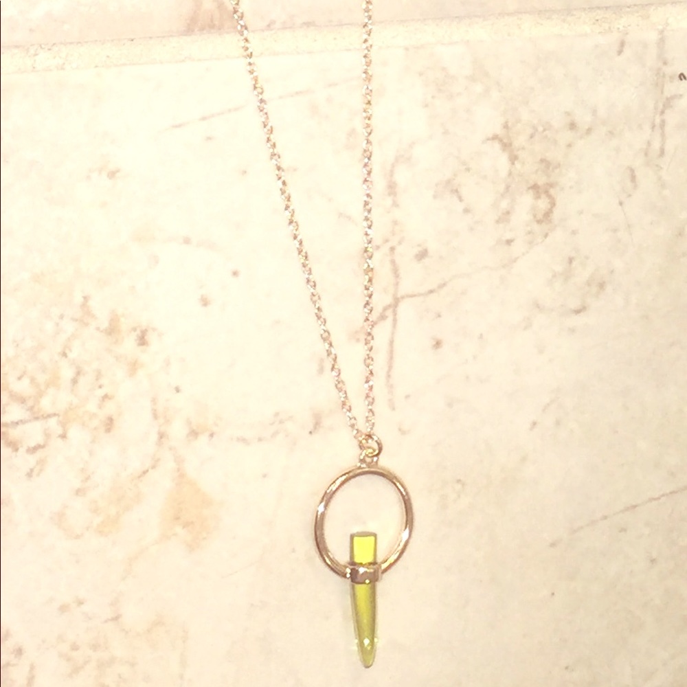 Gold chain necklace with green pendant stone.